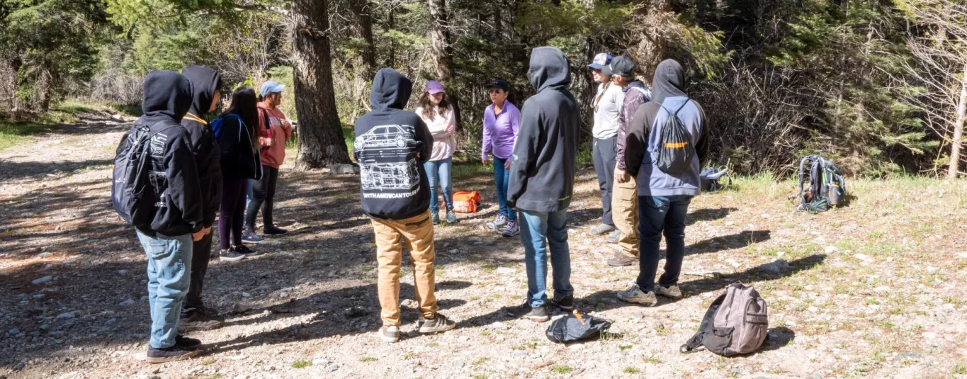 Several Boy and Girl Students with Faculty and Staff at Taos Day School Getting Ready to go On a Day Hike with Their Backbacks.
