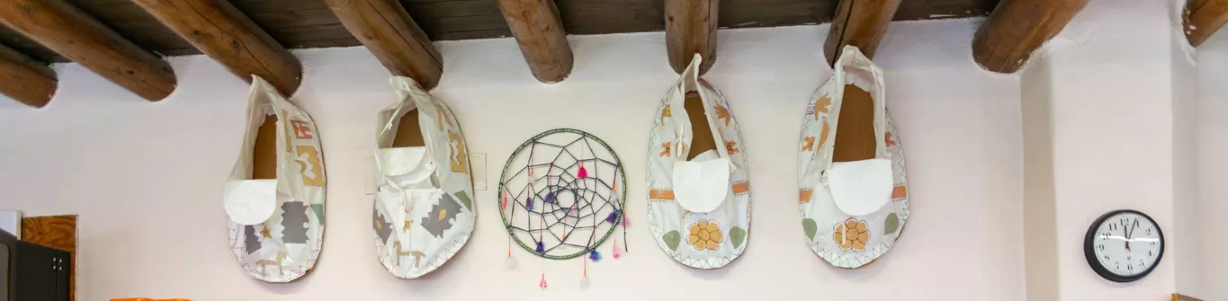 Taos Day School Wall with Two Large Moccasins and a Dream Catcher Used as Wall Décor.