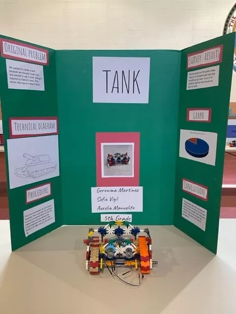 Taos Day School "Tank" Trifold Project Board and Science Project Displayed on Table Inside the Gym.