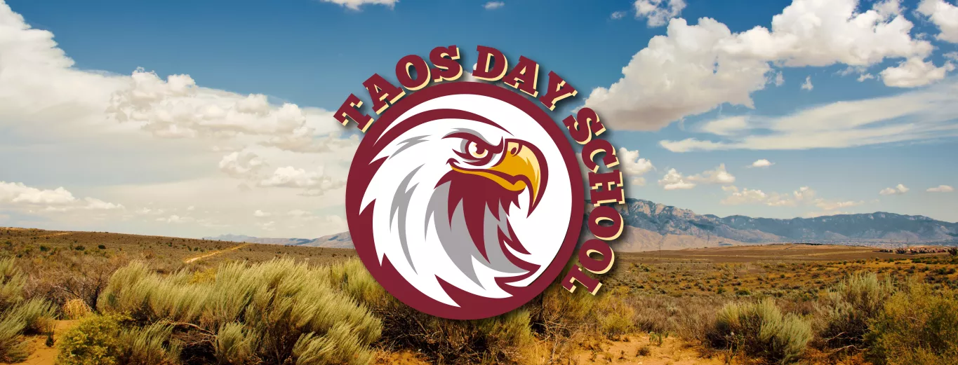 Panoramic View of Reddish Rolling Desert Hills with a Rocky Mountain and Blue Skies with White Clouds in the Background with the Taos Day School Logo Overlay.