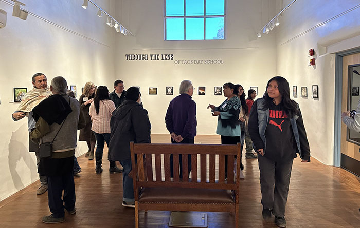 Visitors viewing student photos at the Couse Sharpe Gallery.