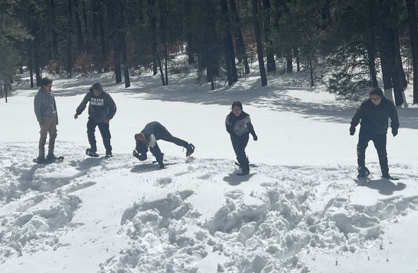 Eighth grade students enjoying some fun time snowshoeing.
