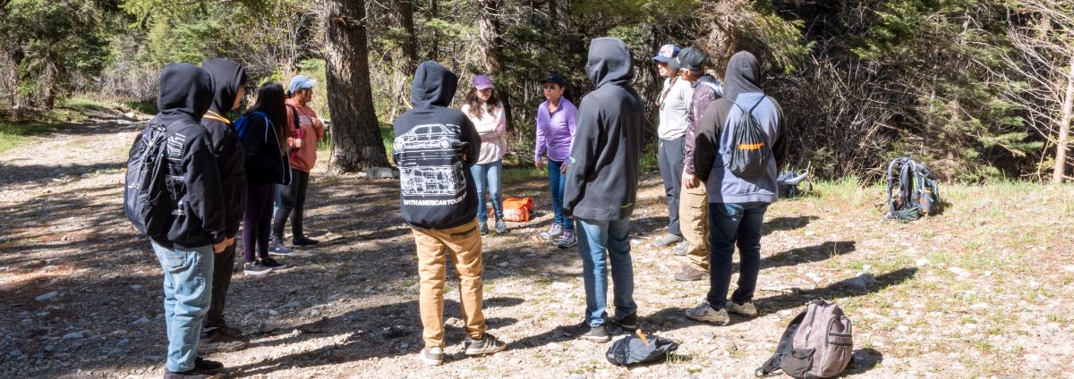 Group of students with backpacks getting ready to go on a hike