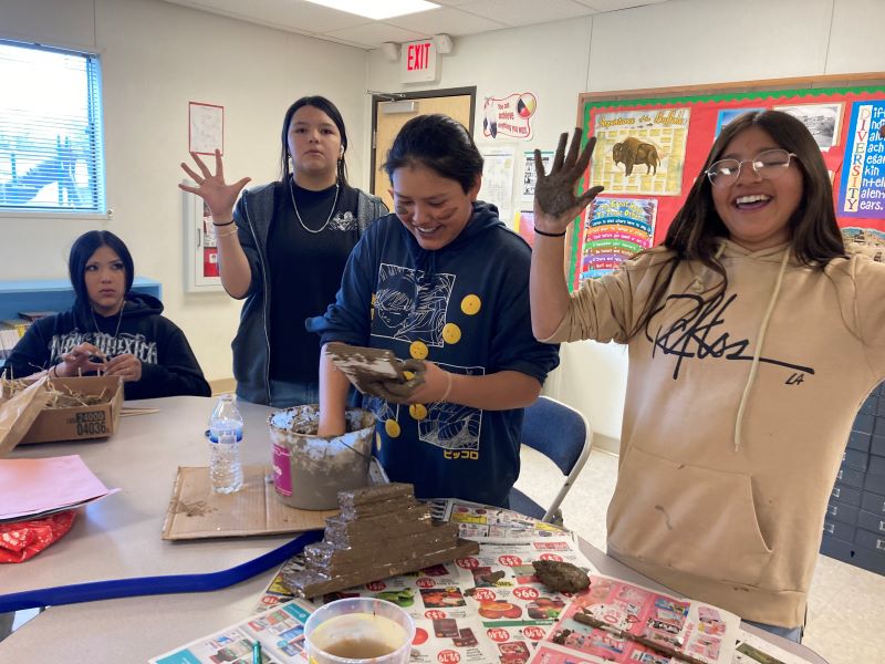 A group of students working on their dioramas in class.