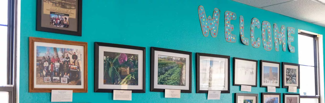 Taos Day School Classroom Wall with Welcome Sign and Plaques with Descriptions Below.