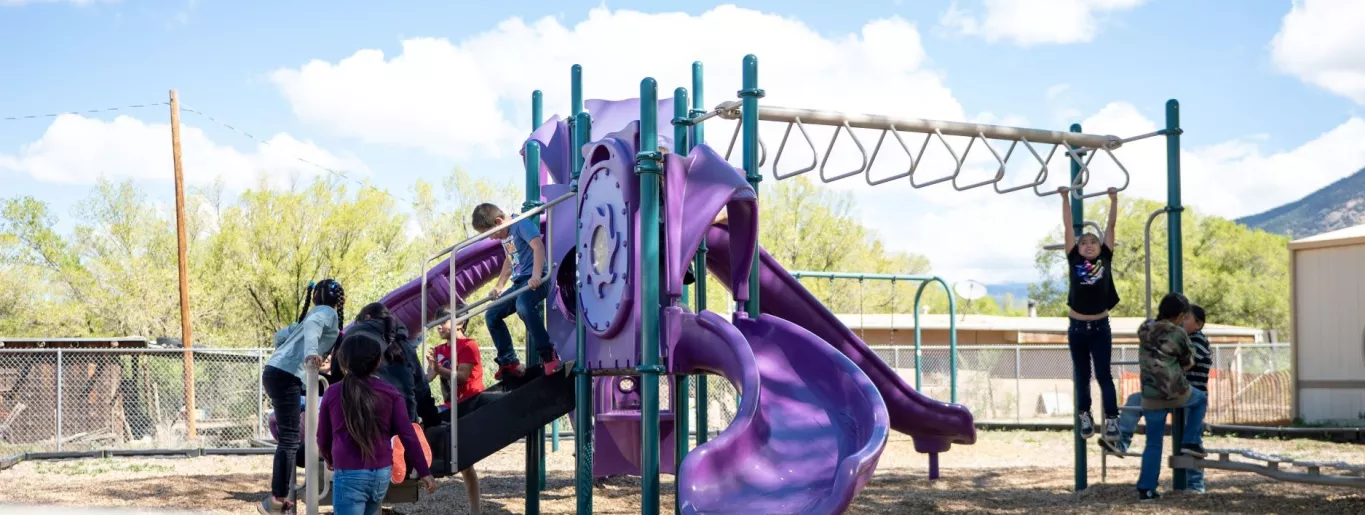 Taos Day School Boy and Girl Students Playing on the School Playground.