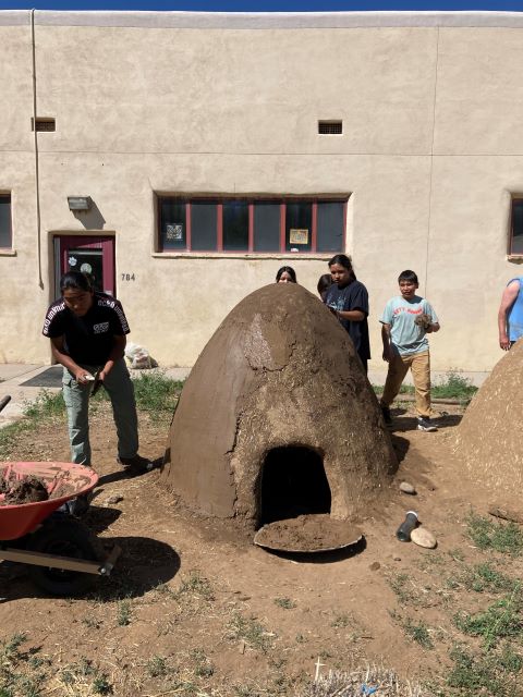 Students working on building a horno outside.