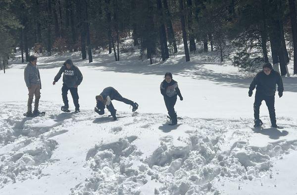 Eighth grade students enjoying some fun time snowshoeing.